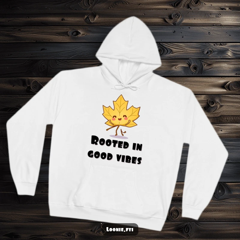 Funny hoodie featuring a playful maple leaf character dancing merrily, embodying fall festivities.
