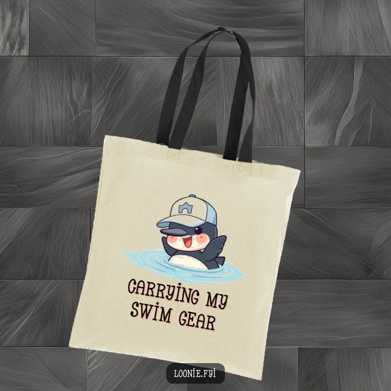 Funny Tote Bag: A cheerful loon in a baseball cap is diving into water, ready for aquatic adventures.