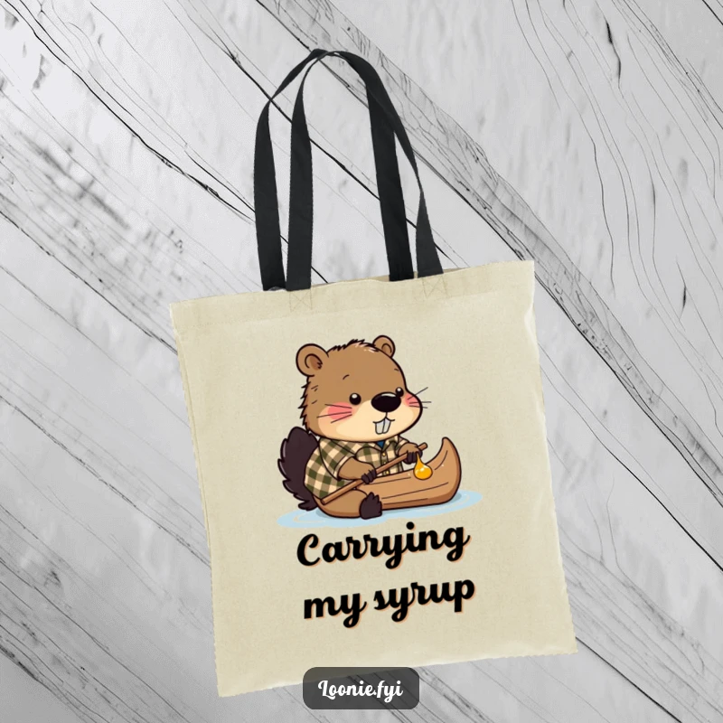 Funny tote bag showcasing a beaver in a plaid shirt, attempting to navigate a canoe made entirely of maple syrup.